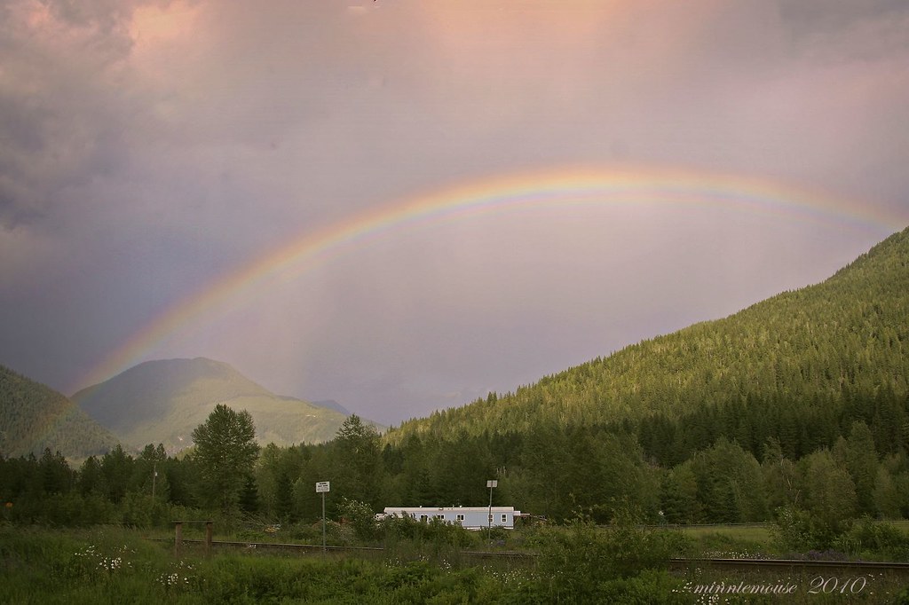 Arcobaleno che si estende tra montagne