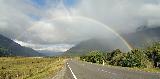 Immagine arcobaleno Arcobaleno sottile sopra strada che porta a montagne