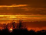 Cielo rossastro con bande orizzontali gialle al tramonto