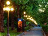 Viale romantico con lampioni accesi e cabina telefonica